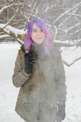 A young woman smokes VAPE.