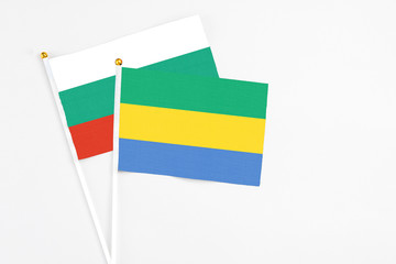 Gabon and Bulgaria stick flags on white background. High quality fabric, miniature national flag....