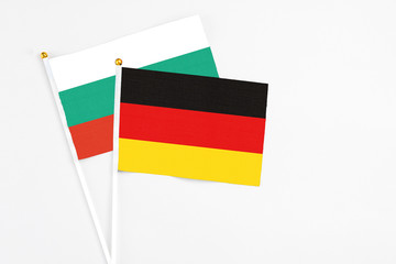 Germany and Bulgaria stick flags on white background. High quality fabric, miniature national flag. Peaceful global concept.White floor for copy space.