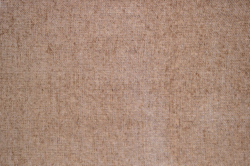 Fototapeta na wymiar brown canvas surface - rough fabric material texture in a blank background