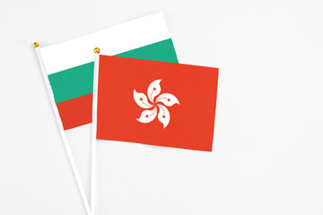 Hong Kong and Bulgaria stick flags on white background. High quality fabric, miniature national flag. Peaceful global concept.White floor for copy space.