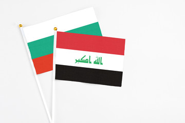 Iraq and Bulgaria stick flags on white background. High quality fabric, miniature national flag. Peaceful global concept.White floor for copy space.