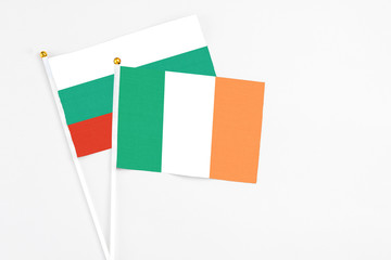 Ireland and Bulgaria stick flags on white background. High quality fabric, miniature national flag. Peaceful global concept.White floor for copy space.