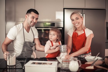 Beautiful family bake christmas cookies. Family cooks in the kitchen. Holidays. Christmas. New Year. Cozy.