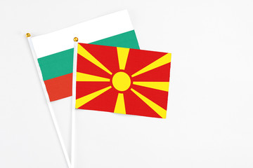 Macedonia and Bulgaria stick flags on white background. High quality fabric, miniature national flag. Peaceful global concept.White floor for copy space.