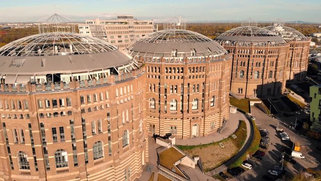 Aerial drone shot of Old Gasometer buidlings in Vienna from up above. Used like gasholders, it is music hall, museum, dormitory and shopping center howadays