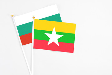 Myanmar and Bulgaria stick flags on white background. High quality fabric, miniature national flag. Peaceful global concept.White floor for copy space.