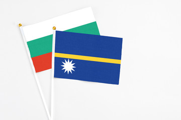 Nauru and Bulgaria stick flags on white background. High quality fabric, miniature national flag....