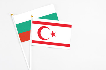 Northern Cyprus and Bulgaria stick flags on white background. High quality fabric, miniature national flag. Peaceful global concept.White floor for copy space.