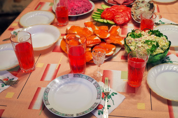 Russian homemade food. Delicious food on the table. Fish salads, vegetables, sandwiches, drinks