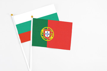 Portugal and Bulgaria stick flags on white background. High quality fabric, miniature national flag. Peaceful global concept.White floor for copy space.