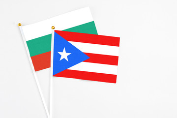 Puerto Rico and Bulgaria stick flags on white background. High quality fabric, miniature national flag. Peaceful global concept.White floor for copy space.