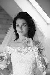monochrome portrait of caucasian beautiful attractive woman bride in traditional european white dress