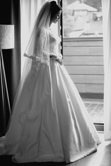 monochrome portrait of caucasian beautiful attractive woman bride in traditional european white dress 