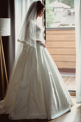 portrait of caucasian beautiful attractive woman bride in traditional european white dress 