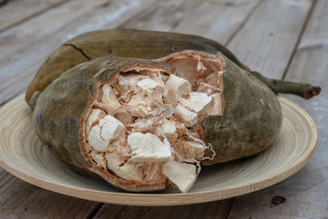 Baobab fruit or Adansonia digitata on plate, pulp and powder, superfood on the island of Zanzibar,...