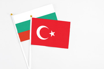 Turkey and Bulgaria stick flags on white background. High quality fabric, miniature national flag. Peaceful global concept.White floor for copy space.