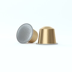 Two golden espresso coffee capsules.