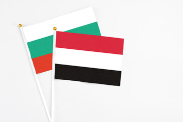 Yemen and Bulgaria stick flags on white background. High quality fabric, miniature national flag. Peaceful global concept.White floor for copy space.