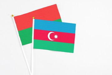 Azerbaijan and Burkina Faso stick flags on white background. High quality fabric, miniature national flag. Peaceful global concept.White floor for copy space.