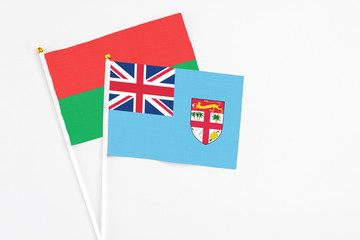 Fiji and Burkina Faso stick flags on white background. High quality fabric, miniature national...
