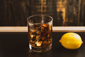 glass of whiskey on a black table