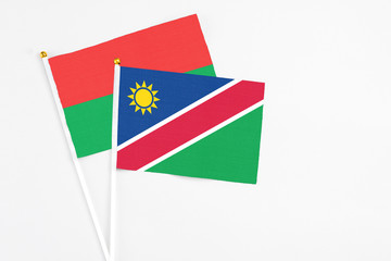 Namibia and Burkina Faso stick flags on white background. High quality fabric, miniature national flag. Peaceful global concept.White floor for copy space.