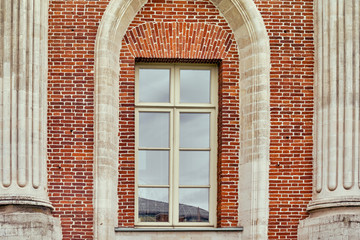 Antique window on a brick wall of a castle, closeup