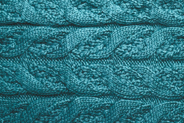 Abstract blue textile background. Loops of wool, yarn with knitting. Ornament on a knitted sweater.