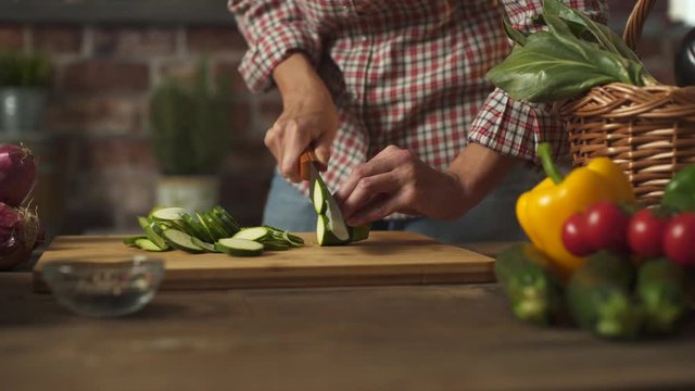 Woman slicing fresh healthy vegetables in the kitchen