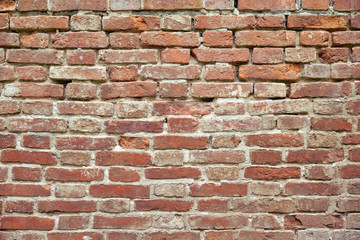 The texture of the cracked walls of red brick, the background of ancient masonry