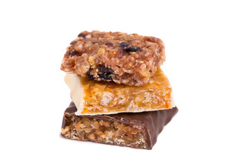 Slices of sweet candies of different tastes close-up. A stack of chocolates. Candy isolate on a white background.