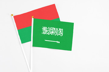 Saudi Arabia and Burkina Faso stick flags on white background. High quality fabric, miniature national flag. Peaceful global concept.White floor for copy space.