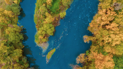 Drone photo of colorful trees and blue river