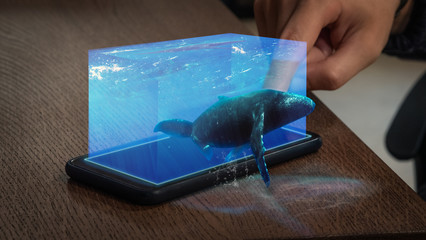 Close up of man's hand is using a futuristic innovative technology smartphone with augmented...
