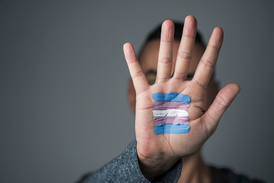 transgender flag in the palm of the hand.