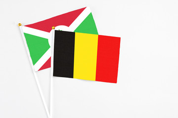 Belgium and Burundi stick flags on white background. High quality fabric, miniature national flag. Peaceful global concept.White floor for copy space.