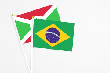 Brazil and Burundi stick flags on white background. High quality fabric, miniature national flag. Peaceful global concept.White floor for copy space.