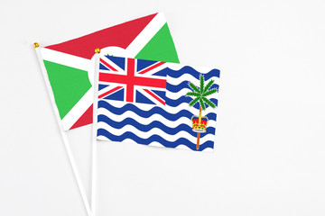 British Indian Ocean Territory and Burundi stick flags on white background. High quality fabric, miniature national flag. Peaceful global concept.White floor for copy space.