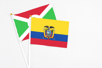 Ecuador and Burundi stick flags on white background. High quality fabric, miniature national flag. Peaceful global concept.White floor for copy space.
