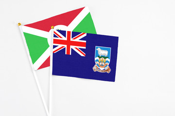 Falkland Islands and Burundi stick flags on white background. High quality fabric, miniature national flag. Peaceful global concept.White floor for copy space.