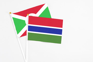 Gambia and Burundi stick flags on white background. High quality fabric, miniature national flag. Peaceful global concept.White floor for copy space.