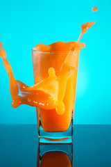 Orange juice in a glass of spray