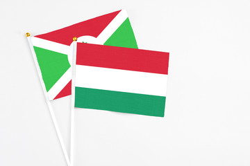 Hungary and Burundi stick flags on white background. High quality fabric, miniature national flag. Peaceful global concept.White floor for copy space.