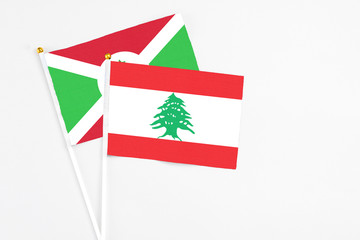 Lebanon and Burundi stick flags on white background. High quality fabric, miniature national flag....
