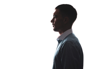 silhouette portrait of a man in profile in a business shirt isolate on white with a copy of the...