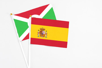 Spain and Burundi stick flags on white background. High quality fabric, miniature national flag. Peaceful global concept.White floor for copy space.