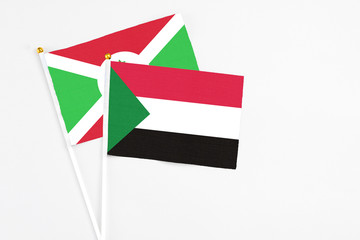 Sudan and Burundi stick flags on white background. High quality fabric, miniature national flag....