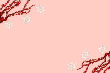 Christmas composition with red berries and snowflake on pink red background. Winter composition with copy space