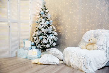 Christmas tree decorated with lights garland. photo studio. Christmas and New Year gifts. room with christmas interior